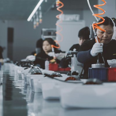 Workers on an automated production line during mass production